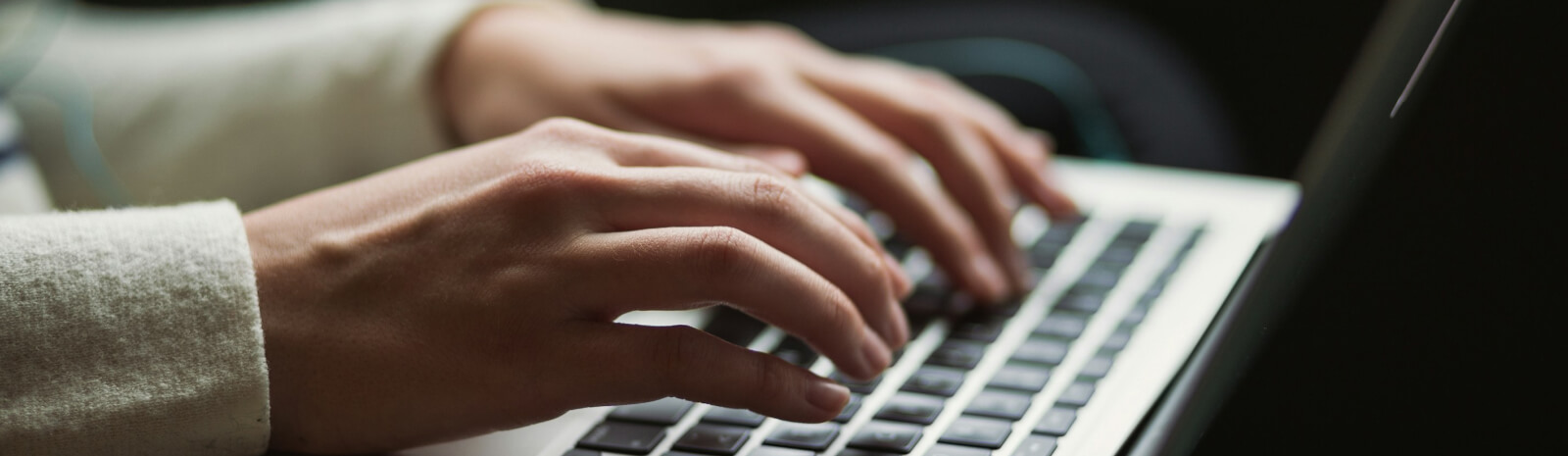 hands on a laptop computer