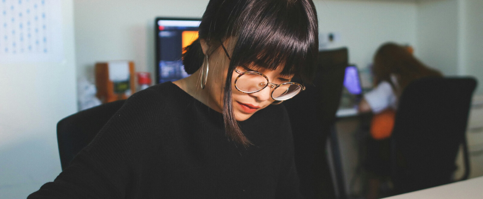 Asian American woman working at desk