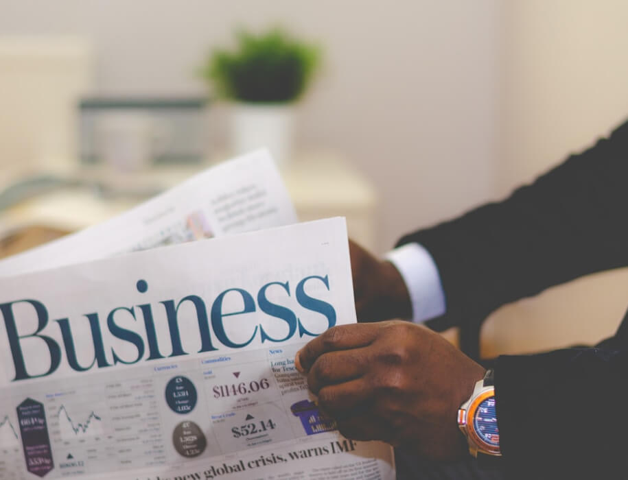 Business newspaper being read by a business man
