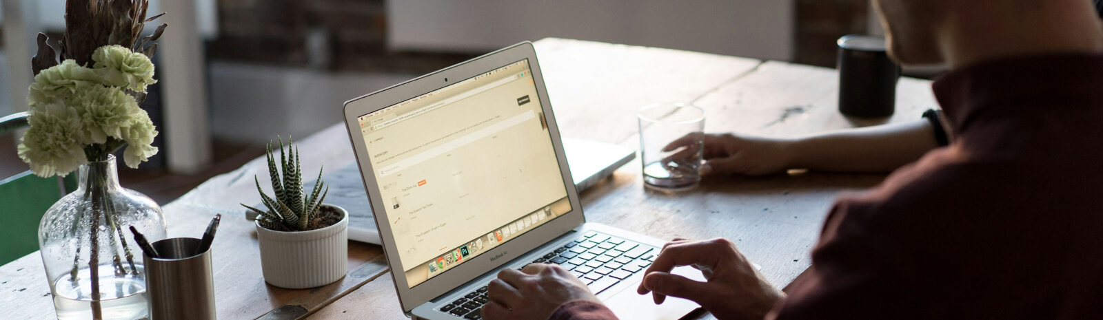 person using a laptop looking over a bank loan on the screen
