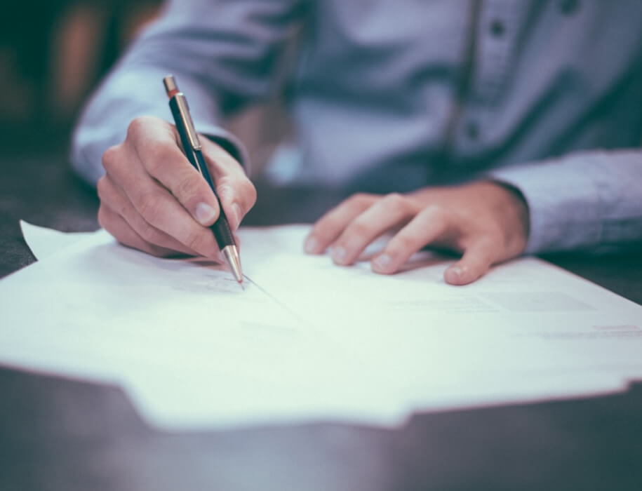 man writing up business loan paperwork