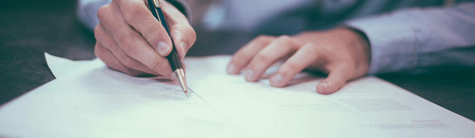 man writing up annual reports for First General Bank
